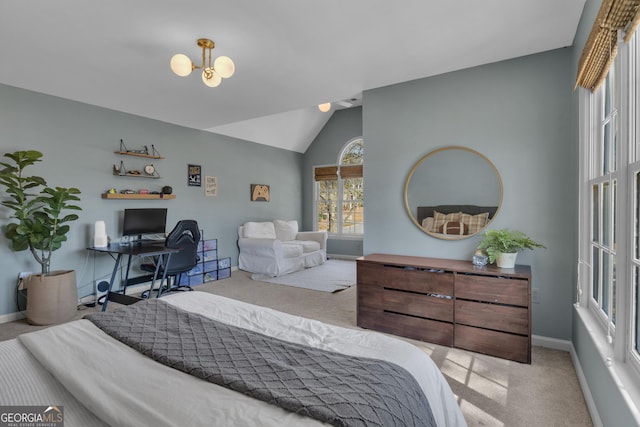 carpeted bedroom featuring baseboards, a chandelier, and vaulted ceiling