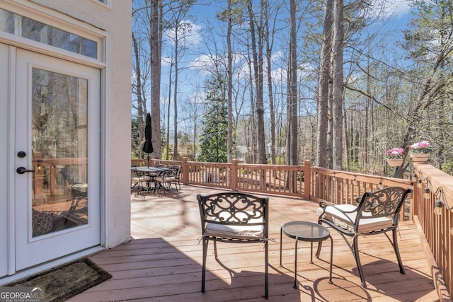 deck with outdoor dining area