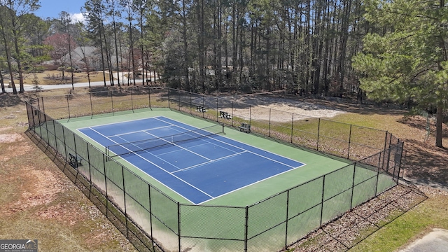 view of tennis court featuring fence