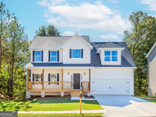 view of front of house with an attached garage, concrete driveway, a porch, and a front yard