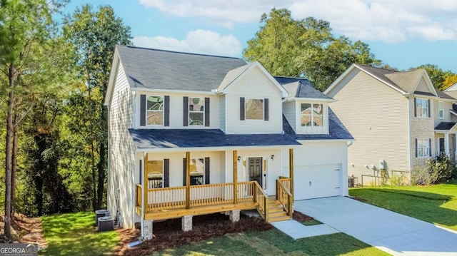 modern inspired farmhouse featuring central air condition unit, a porch, an attached garage, driveway, and a front lawn