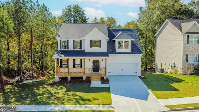 view of front of house featuring a garage, driveway, a porch, and a front lawn