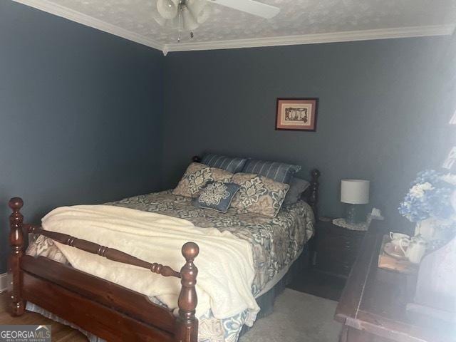 bedroom featuring carpet floors, ornamental molding, and a ceiling fan