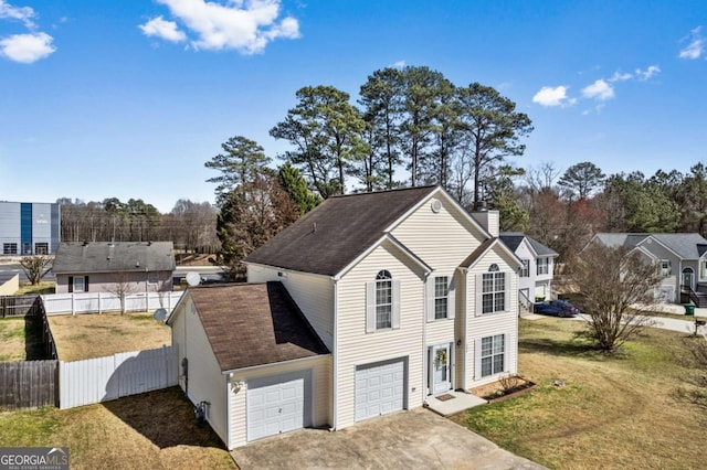 view of front facade featuring fence, driveway, roof with shingles, a chimney, and a front yard