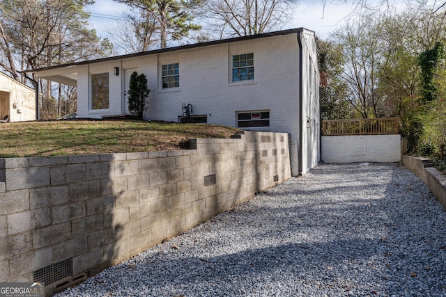 view of front of house with brick siding and fence