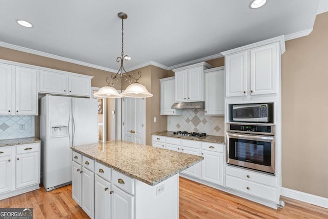 994 Fairview Club Cir, Dacula, GA 30019 - kitchen featuring white cabinets, under cabinet range hood, backsplash, a center island, and appliances with stainless steel finishes