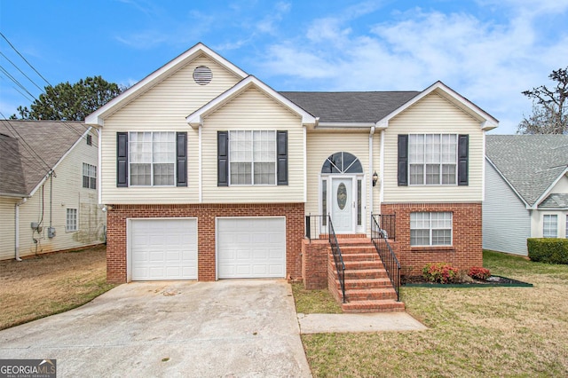 bi-level home with concrete driveway, an attached garage, brick siding, and a front lawn