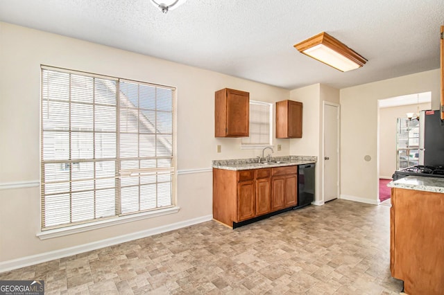 kitchen featuring brown cabinets, black appliances, and baseboards