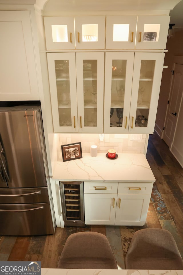 793 Round Tree Ct, Lawrenceville, GA 30045 - bar with dark wood-style floors, backsplash, beverage cooler, and freestanding refrigerator