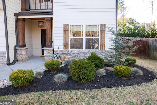 793 Round Tree Ct, Lawrenceville, GA 30045 - doorway to property with stone siding and fence