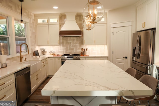 793 Round Tree Ct, Lawrenceville, GA 30045 - kitchen with premium range hood, a breakfast bar, a sink, tasteful backsplash, and stainless steel appliances