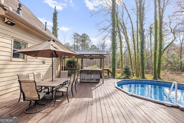 exterior space featuring outdoor dining space and an outdoor pool