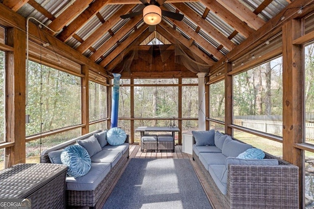 unfurnished sunroom featuring lofted ceiling and ceiling fan