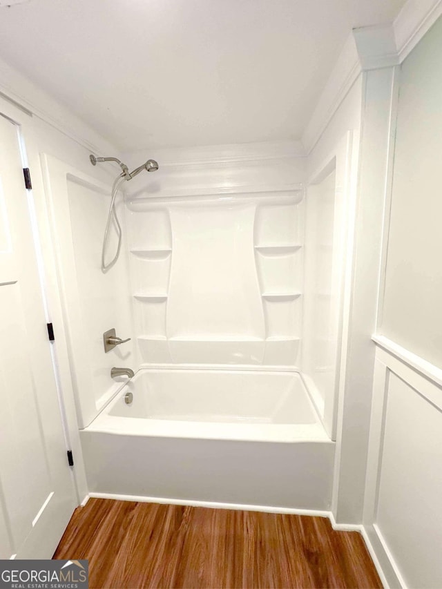 bathroom with shower / washtub combination and wood finished floors