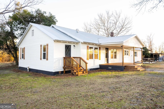 view of front of house featuring a front yard and metal roof