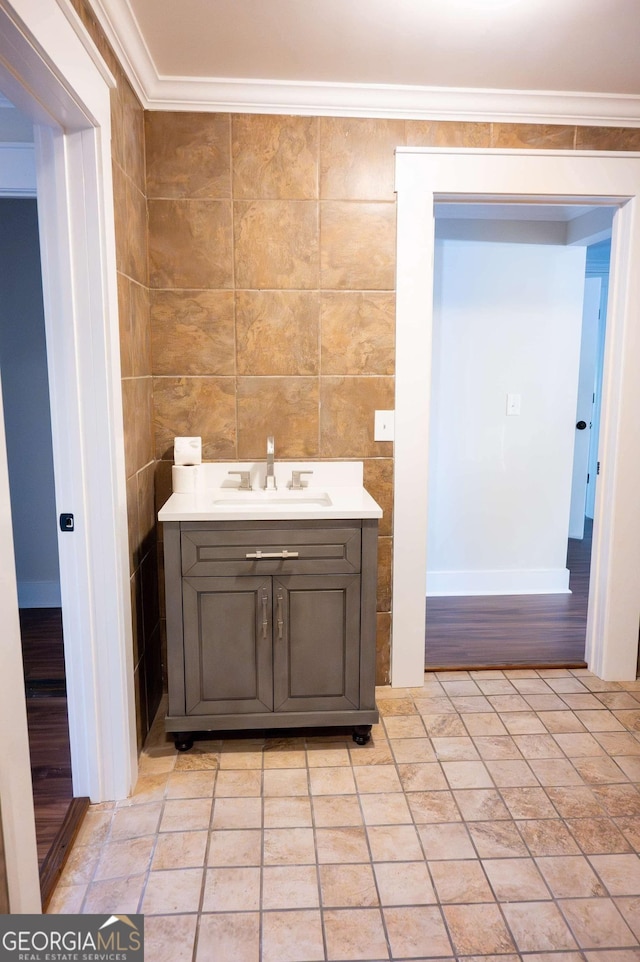 bathroom with ornamental molding and vanity