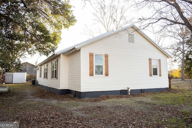 view of property exterior with central air condition unit and crawl space