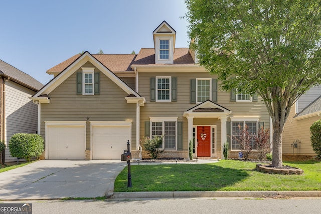 view of front of house featuring a front yard, driveway, a shingled roof, a garage, and brick siding