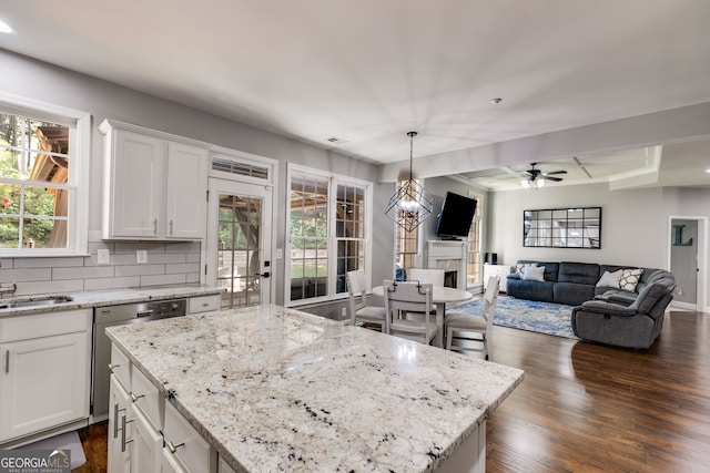 kitchen featuring a high end fireplace, white cabinetry, decorative backsplash, dishwasher, and dark wood-style flooring