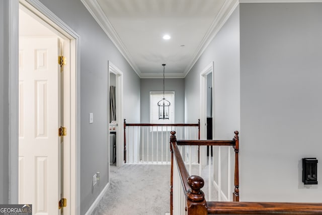 corridor featuring an upstairs landing, light carpet, baseboards, and ornamental molding