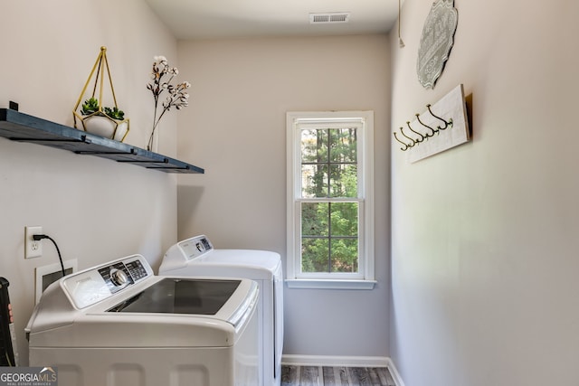 laundry room with visible vents, plenty of natural light, separate washer and dryer, and laundry area