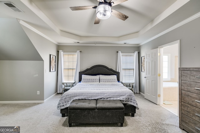 carpeted bedroom with visible vents, a tray ceiling, and ornamental molding