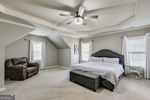 carpeted bedroom featuring visible vents, a raised ceiling, and multiple windows