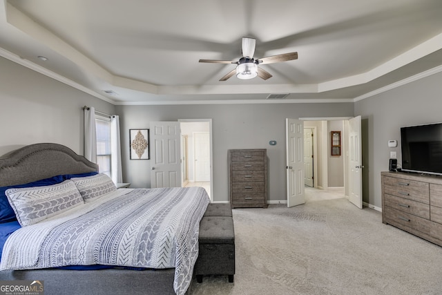 bedroom with carpet, baseboards, visible vents, a tray ceiling, and ornamental molding