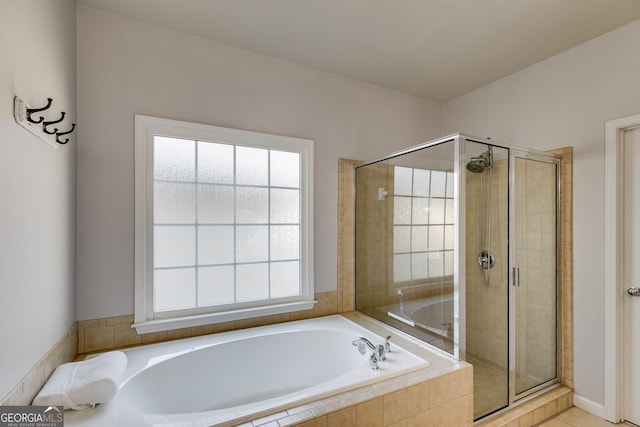 full bathroom featuring a garden tub and a stall shower