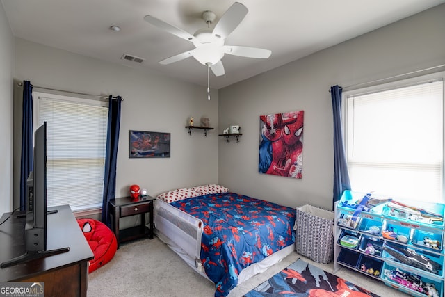 carpeted bedroom featuring visible vents and ceiling fan