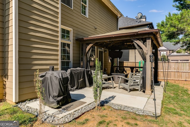 view of patio with a gazebo, fence, and grilling area