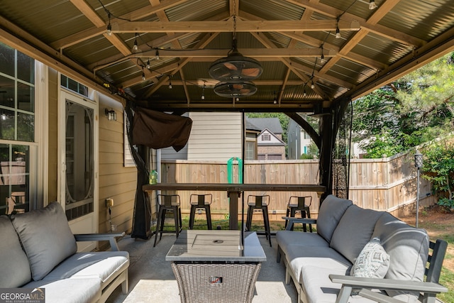 view of patio featuring a gazebo, an outdoor hangout area, and fence