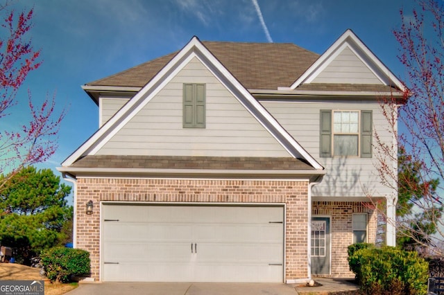 traditional home featuring concrete driveway and brick siding