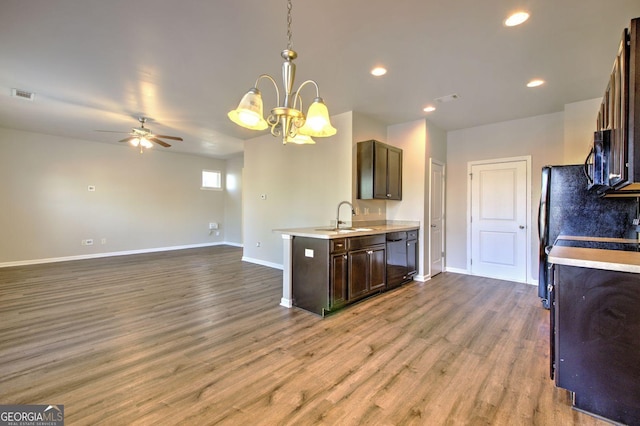 kitchen featuring light countertops, visible vents, a sink, and wood finished floors