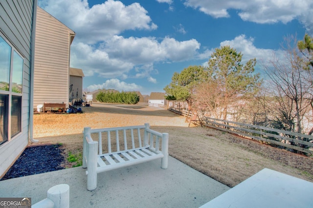 view of yard with fence and a patio