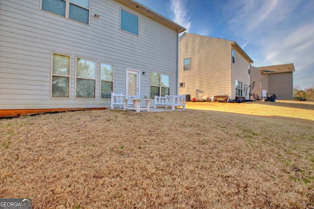 rear view of property with a lawn