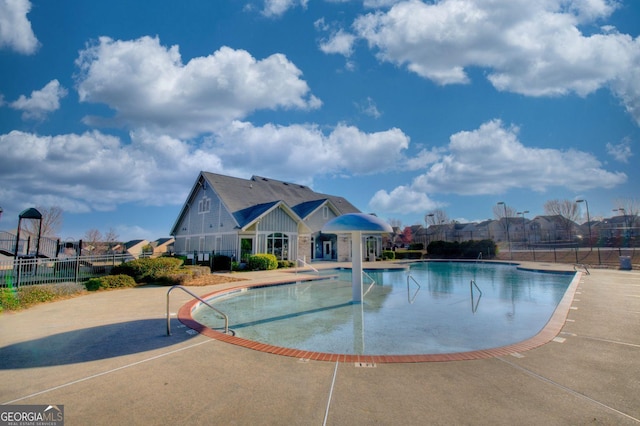 pool with fence and a patio