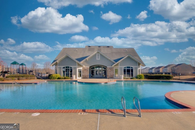 community pool featuring a patio area and fence