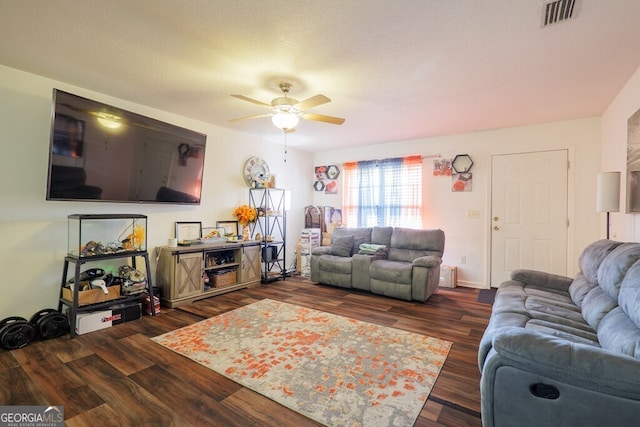 living area featuring a ceiling fan, visible vents, a textured ceiling, and wood finished floors