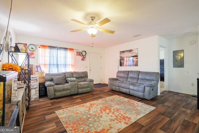 living room featuring visible vents, ceiling fan, wood finished floors, electric panel, and baseboards