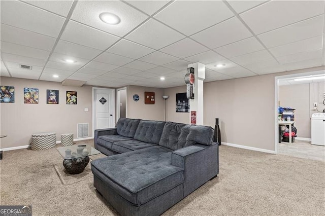 carpeted living area featuring washer / dryer, baseboards, and visible vents