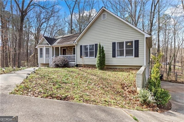 ranch-style house with a front lawn and a porch