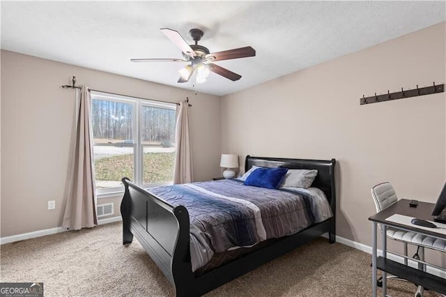 carpeted bedroom with ceiling fan, visible vents, and baseboards