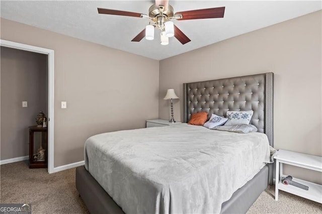 carpeted bedroom with a ceiling fan and baseboards