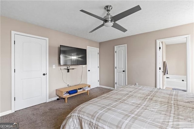 carpeted bedroom with ceiling fan, baseboards, and ensuite bathroom