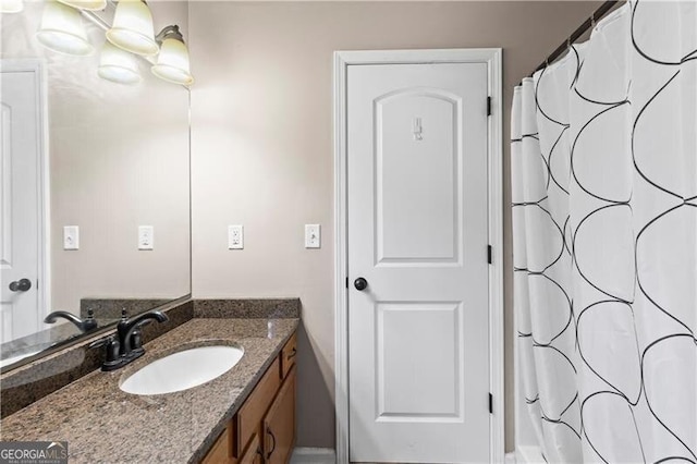 full bath featuring vanity and a shower with shower curtain