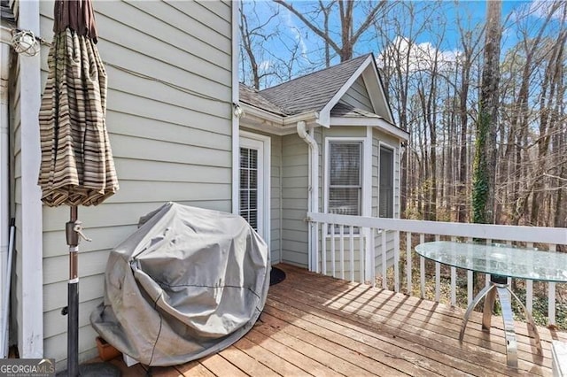 wooden deck featuring a grill