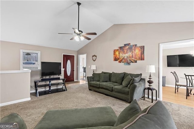 living area featuring carpet floors, lofted ceiling, ceiling fan, and baseboards