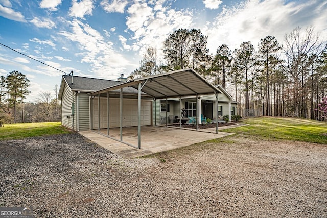 rear view of house with a yard, driveway, a carport, and a garage