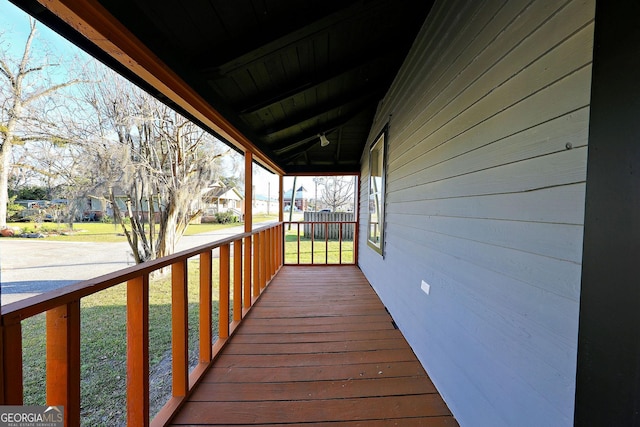 wooden terrace with a porch and a residential view